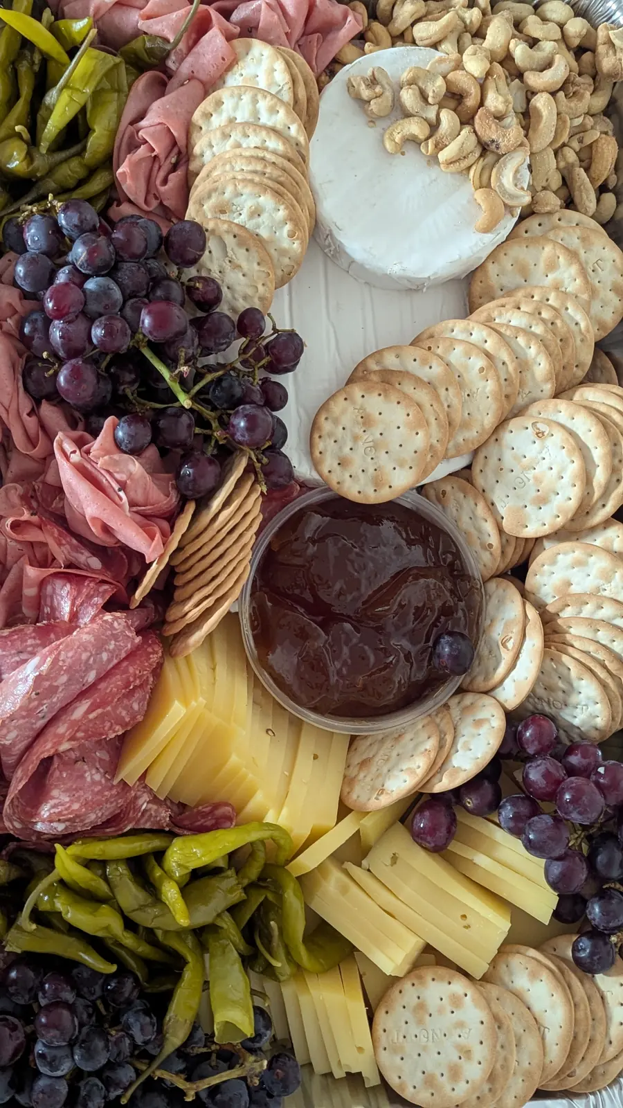 An antipasto board with fruit and cured meat