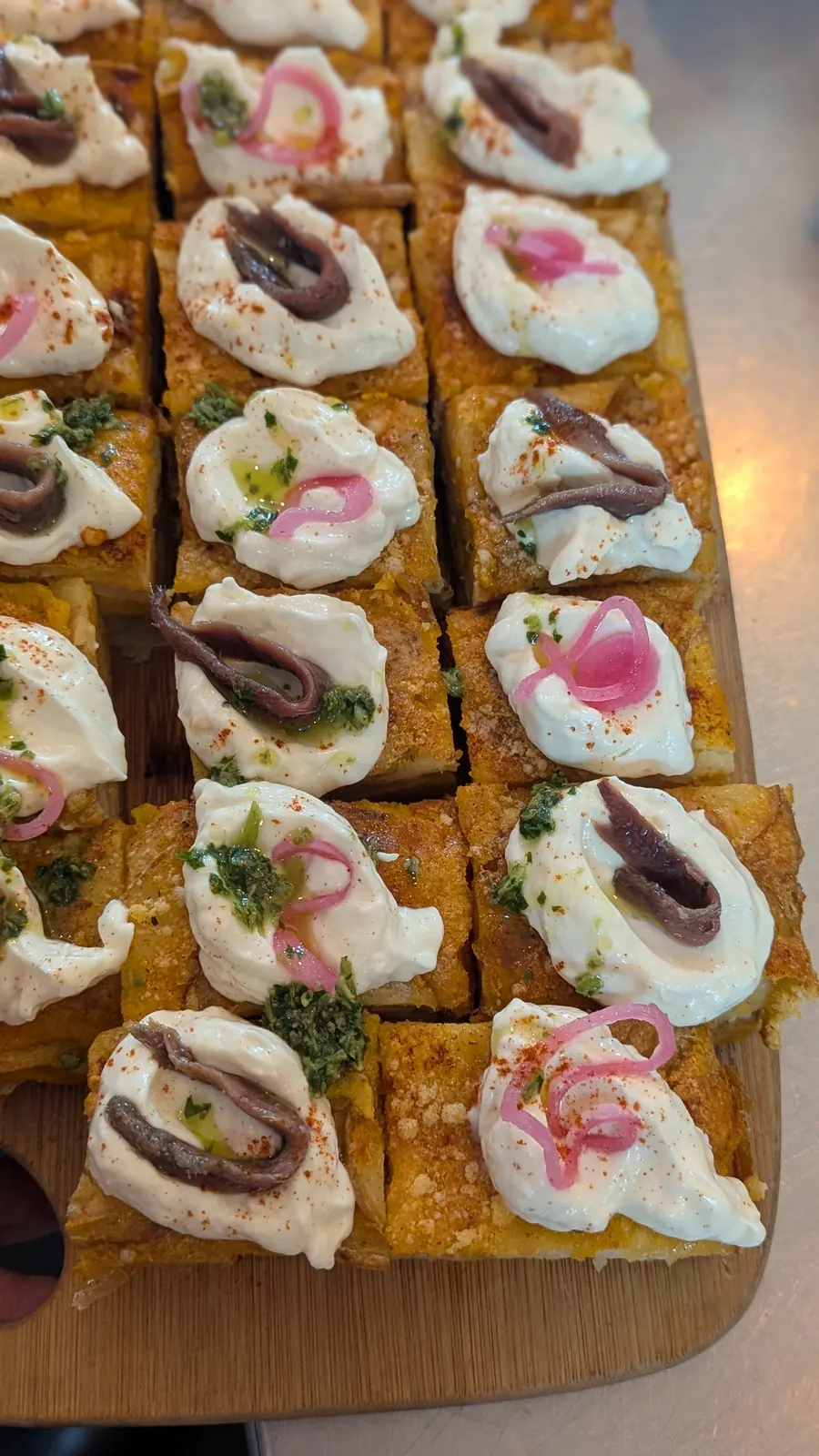 Canapés topped with cream and anchovy