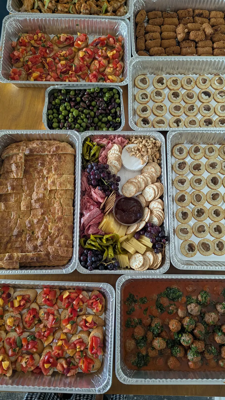 Trays of food laid out for a large catering order.